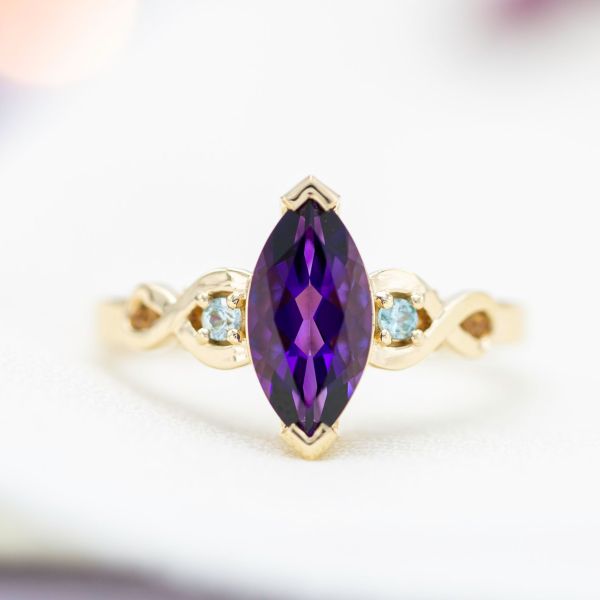 We used secure v-prongs to protect the more vulnerable points of the marquise cut amethyst in this engagement ring.