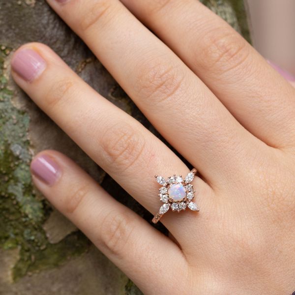 There's plenty of diamond sparkle around the Northern Lights coloration of this engagement ring's opal center stone.