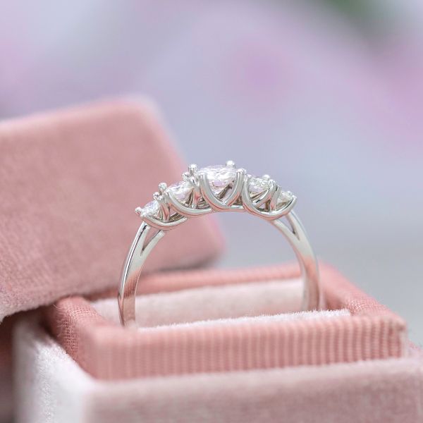 This five-stone ring uses a beautiful trellis setting visible from the side of the ring.