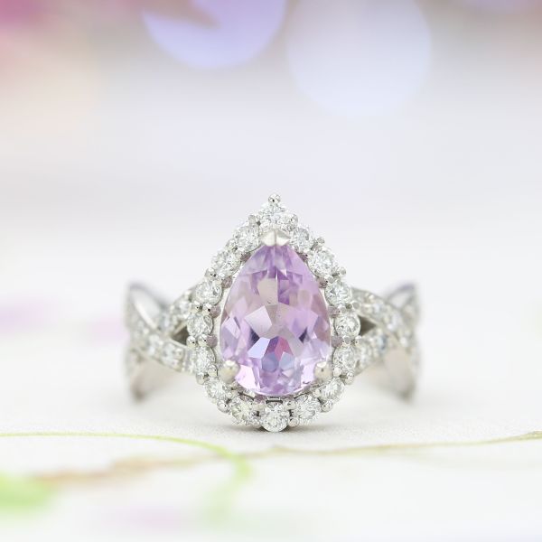 A pear cut rose de France engagement ring with a twisting platinum shank and loads of diamond sparkle.