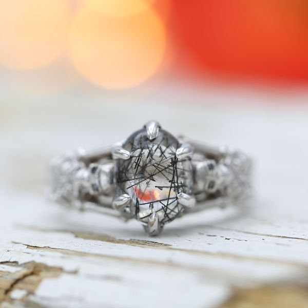 A skeleton engagement ring featuring the unique look of tourmalinated quartz at its center.