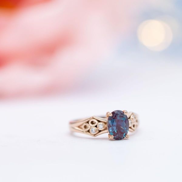 Rose gold and alexandrite engagement ring with pear cut diamond accents.