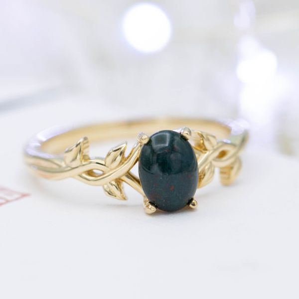 A nature-inspired bloodstone engagement ring in yellow gold.