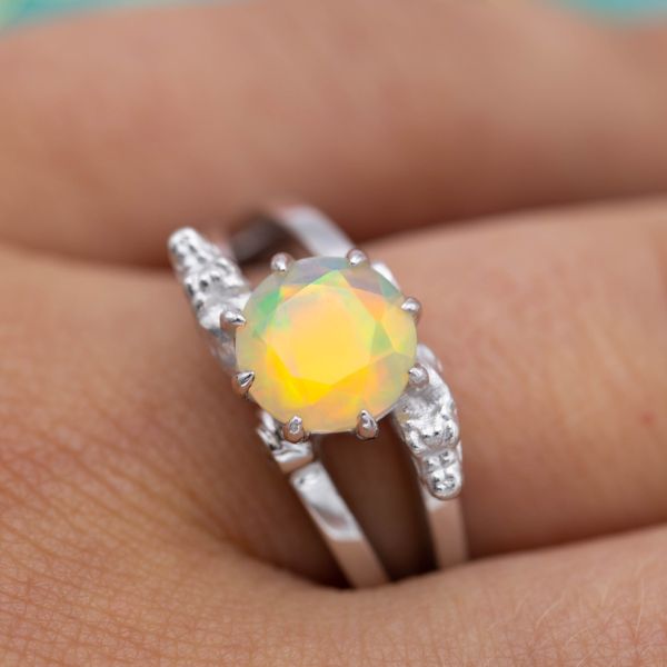 This unusual, faceted opal's warm colors almost seem to glow.