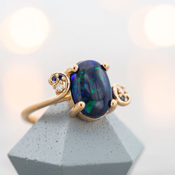 This black opal's coloring is mostly a dark, vivid blue.