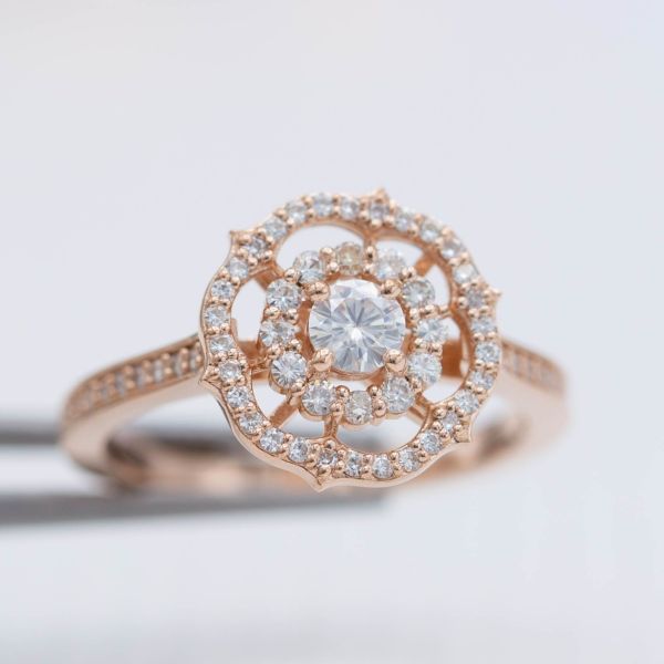 A snowflake-like ring balances a scalloped halo and antique frame halo and lots of open space to create a unique, balanced ring design.