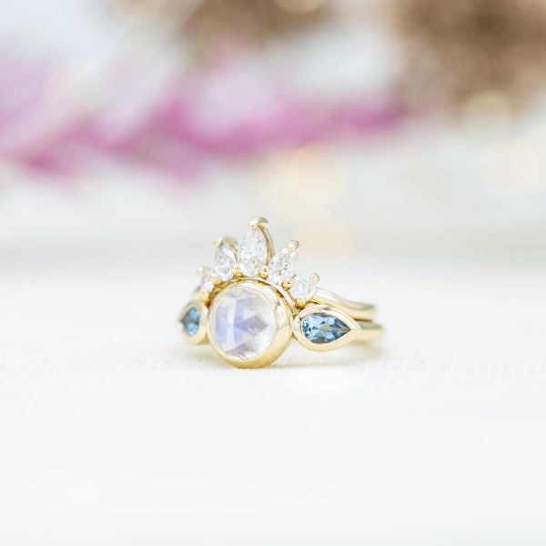 Rose cut moonstone engagement ring with aquamarine accents a diamond tiara wedding band.