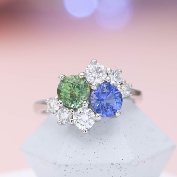 This cluster ring's two-stone center features a lighter green Montana sapphire and a matching shade of medium blue sapphire.