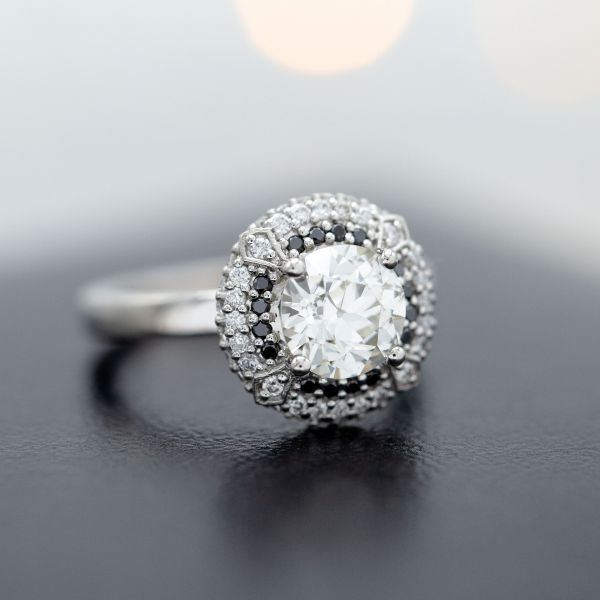 Deco-inspired double halo engagement ring with an old European cut diamond center stone.