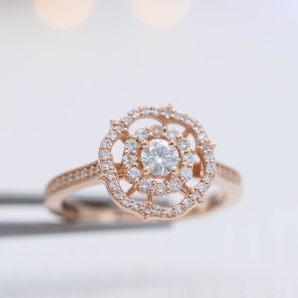 This ring brings together familiar elements like a scalloped halo into a unique and distinctive snowflake-reminiscent setting.