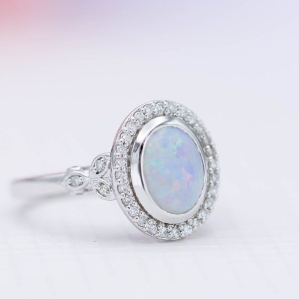 A white opal with predominantly blue color play.