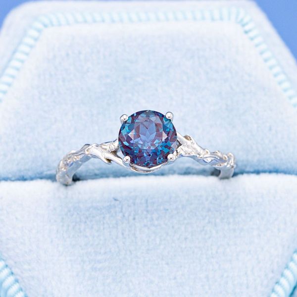 Branches of white gold hold this brilliant round alexandrite.