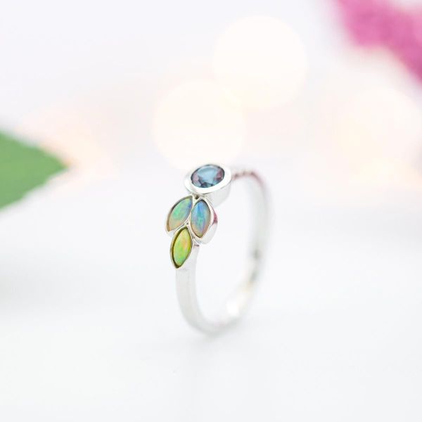 Alexandrite and marquise cut white opals in an asymmetric engagement ring design.
