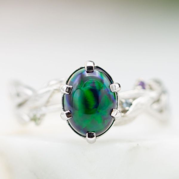 A black opal with rich, saturated blues and greens steals the show in this white gold engagement ring.