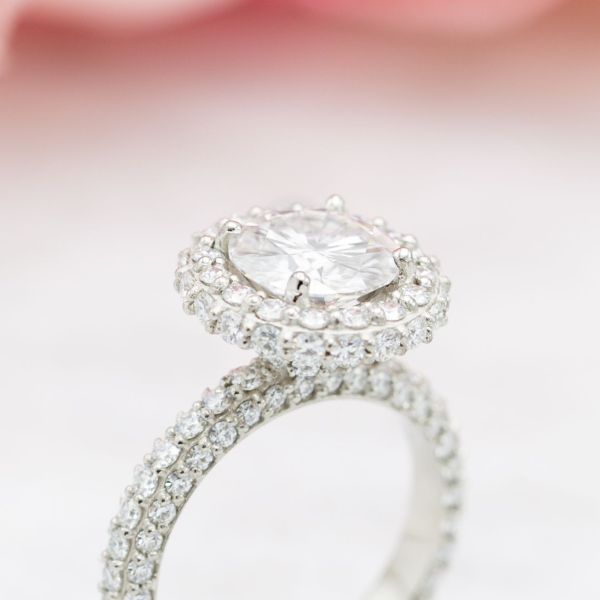 Every surface of this ring is diamond-encrusted, including a side halo on the outer edge and a standard halo facing up.