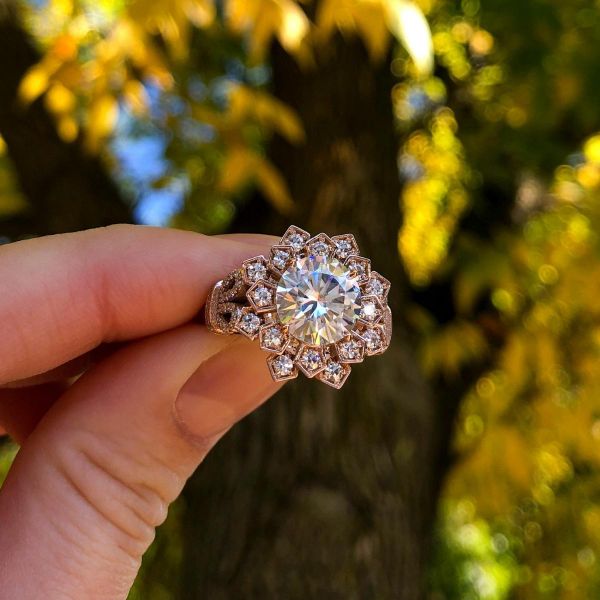 The sunlight brings out the rainbow fire of this halo moissanite ring.