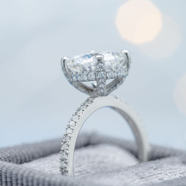 The gallery rail holding up this ring's diamond center stone is lined with diamonds to create a look much like a falling edge halo.