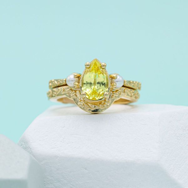 1.9 carat yellow sapphire stone in a yellow gold bridal set.