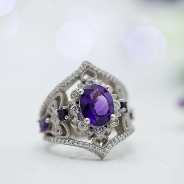 A bold, vintage-inspired engagement ring we designed with an amethyst center stone and tons of CanadaMark diamonds adding sparkle.