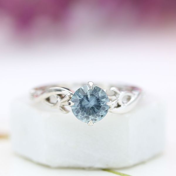 This branching engagement ring shows off a smoky, pale blue Montana sapphire center stone.