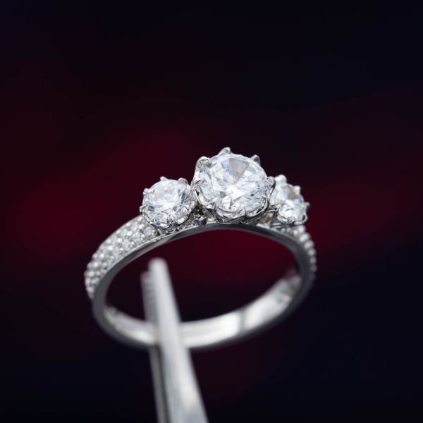 A three-stone CZ ring looks pretty and quite sparkly, but the center stones will dull with time and need to be replaced.