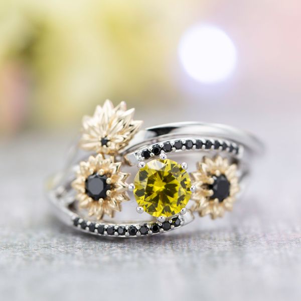 This yellow sapphire engagement ring uses mixed gold colors and black spinel to create a beautiful sunflower cluster.