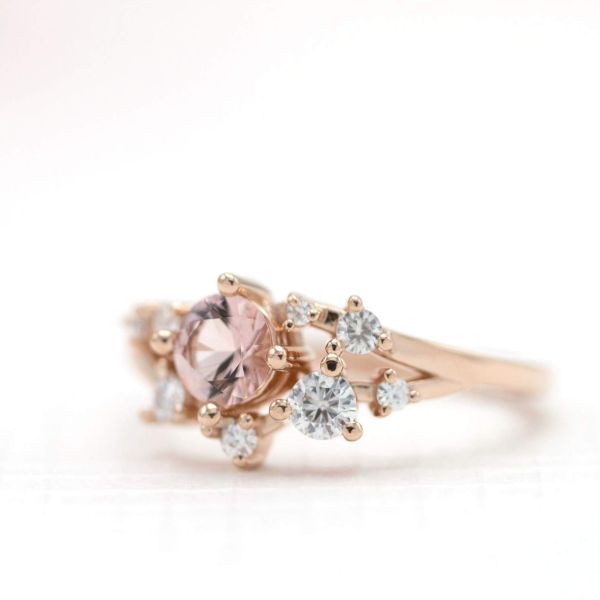 This delicate cluster ring combines morganite and diamonds in an open, modern, sparkly setting.