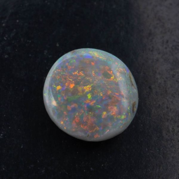 Dark opal with multi-colored flash.