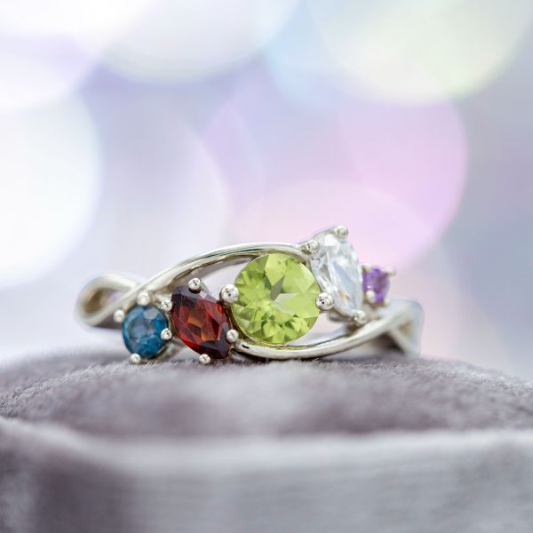 Whimsical cluster engagement ring with peridot, garnet, topaz and amethyst.
