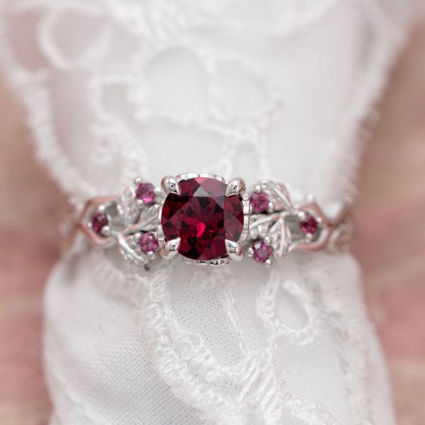 The pinkish-red of rhodolite garnet is the start of this nature-inspired engagement ring.