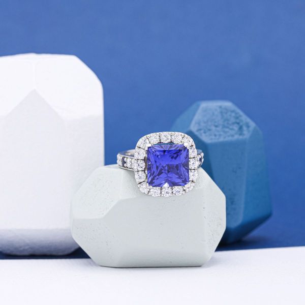 A blue sapphire in white gold with a diamond halo.