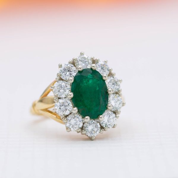 A vintage-inspired emerald ring with a scalloped halo of chunky diamonds.