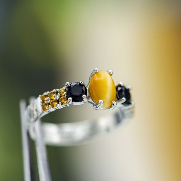 A honey-colored tiger's eye engagement ring with black onyx and citrine.