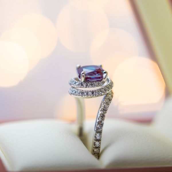 A spiral of diamonds creates a nest of sparkle for a beautiful alexandrite center stone.
