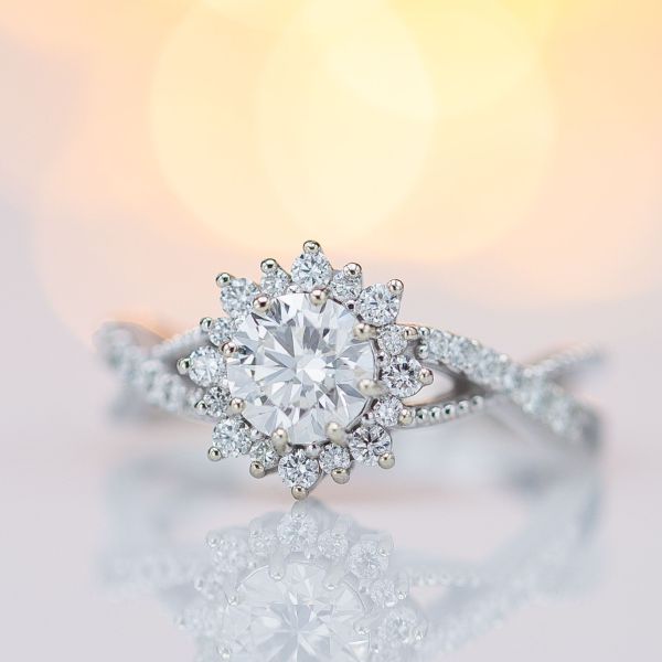 The bright sunburst halo of this diamond engagement ring sparkles like crazy.