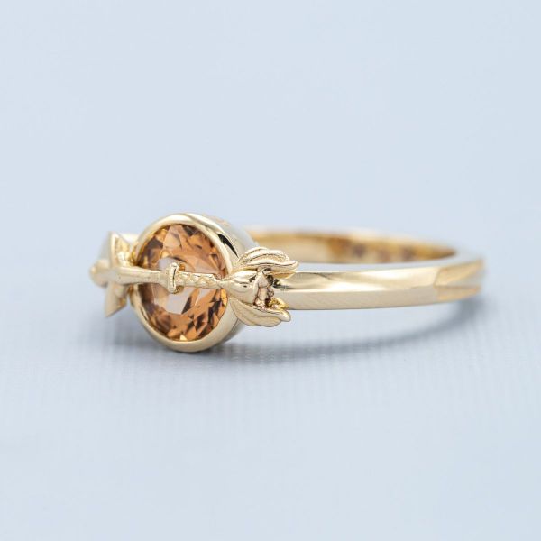 This superhero inspired ring resembles She-Ra’s sword while the center shines with its Imperial topaz center stone.