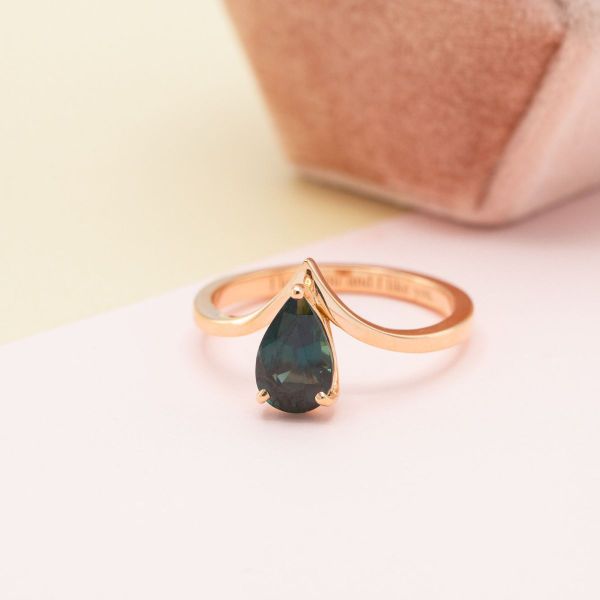 Teal sapphire in a rose gold band.