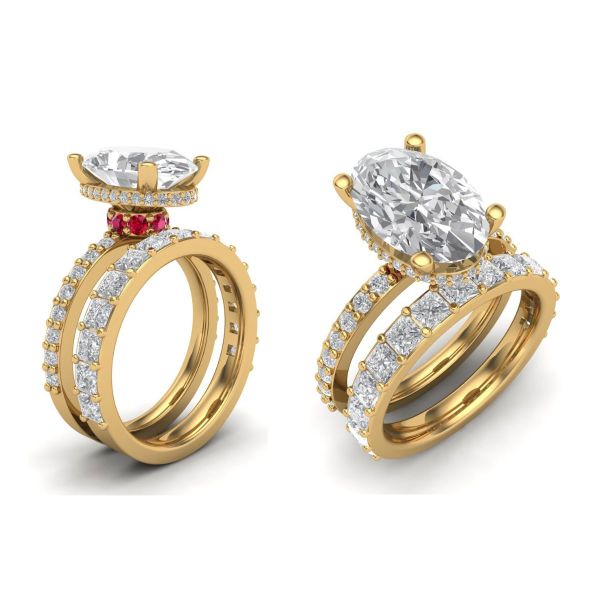 A hidden halo of pavé-set moissanites circles around this bling engagement ring’s oval cut moissanite as a regal red halo of rubies sits underneath.