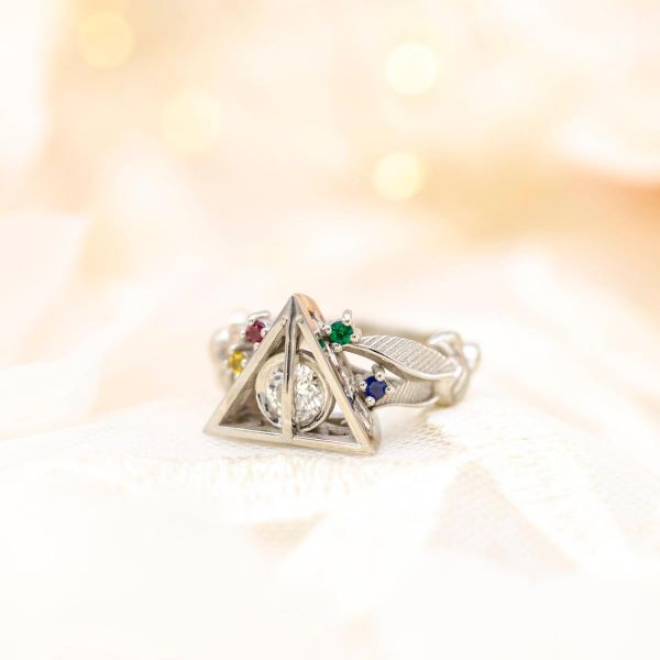 All four Hogwarts houses are represented in this deathly hallows engagement ring.