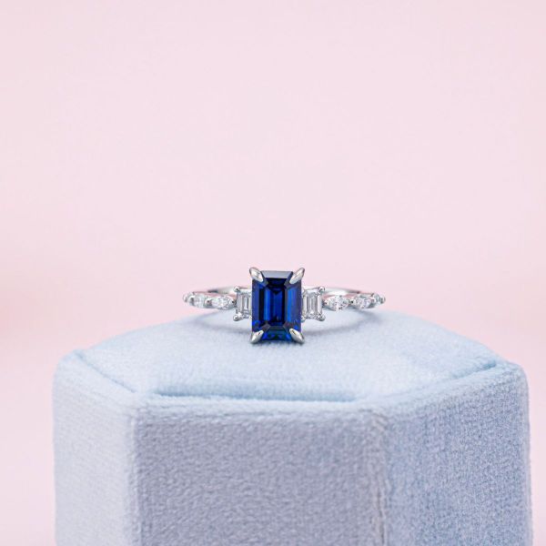 Medium blue sapphire in an emerald cut and white gold setting.
