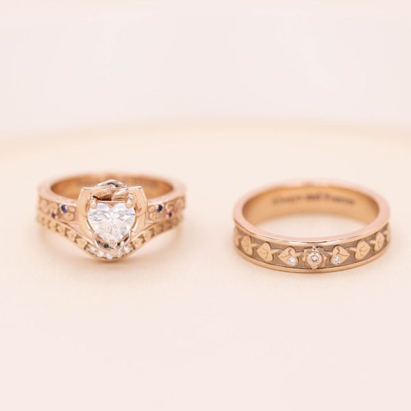 Roses adorn a matching Mr and Mrs set of rings featuring diamonds, rubies, and sapphires
