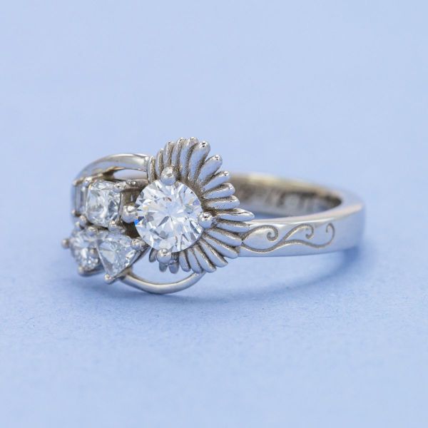 This Art Nouveau inspired engagement ring features a cluster of diamonds and the bride’s favorite flower.