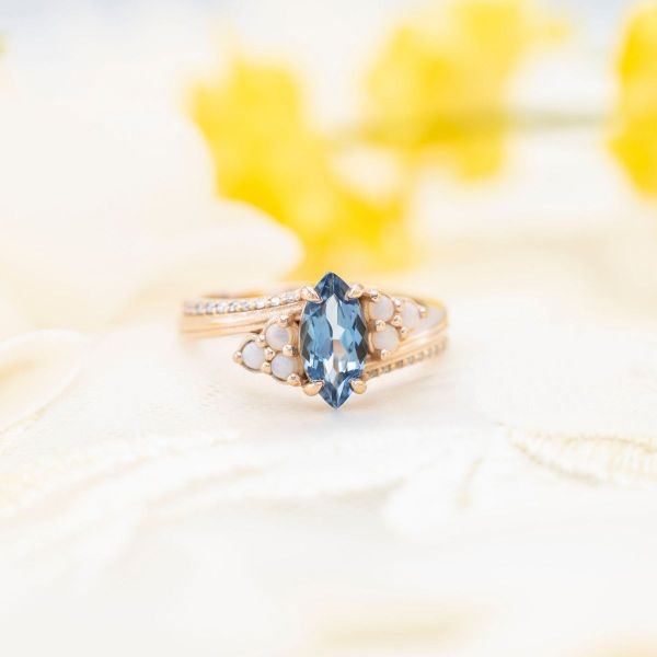 How original is this marquise cut for the aquamarine, especially when accented by opals!