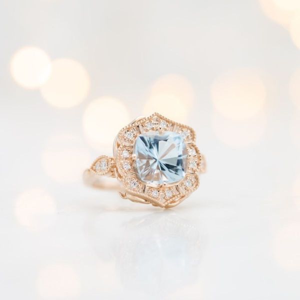 The antique inspired design of this setting holds a beautiful cushion cut aquamarine.