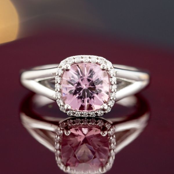 A violet-tinged pink morganite custom cut in a cushion shape. Halo and split shank with sleek edges for a modern feel.