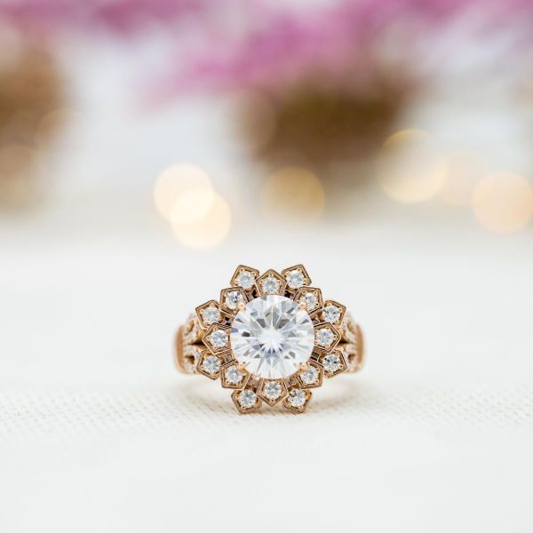 A bold, geometric engagement ring with tons of moissanite sparkle for its flower/snowflake design.