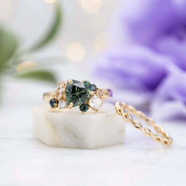 A stunning cluster engagement ring featuring a trillion green Montana sapphire, diamonds, morganite, and alexandrite.