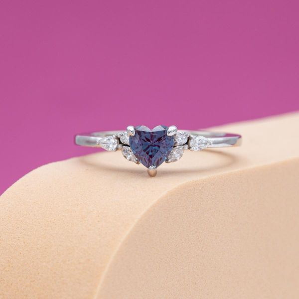A heart shape gives a romantic touch to this alexandrite engagement ring.