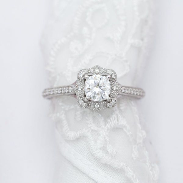 This vintage-style moissanite engagement ring holds a peekaboo paw personalization.