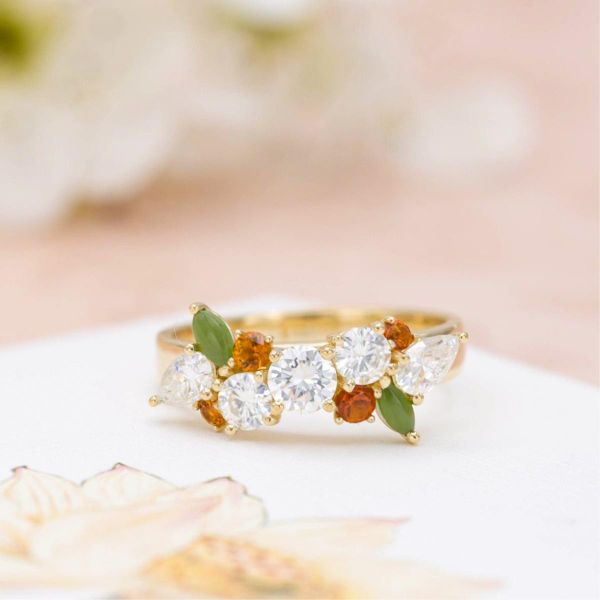 This cluster-style anniversary ring complements the couple's original diamond with citrine, jade and more diamonds.